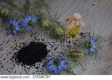 Black Cumin (nigella Sativa Or Kalonji) Seeds In Heart-shaped Bowl On Wooden Background