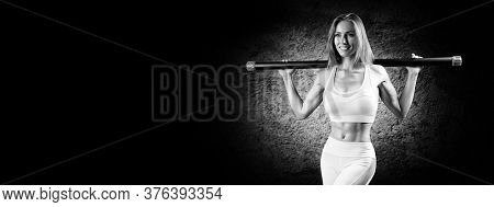 Charming Girl Posing With A Bodybar. The Concept Of Fitness, Bodybuilding And Healthy Lifestyle.