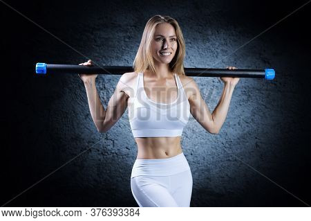 Charming Girl Posing With A Bodybar. The Concept Of Fitness, Bodybuilding And Healthy Lifestyle.