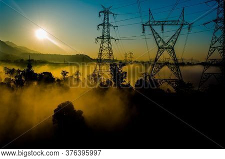 Sun Rays Coming Through The Trees And Electric Towers With Fog Enhancing The Light At Sunrise, Aeria