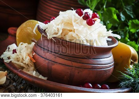 Traditional Russian Sauerkraut With Pickled Apples And Cranberries In A Clayware, Black Background, 