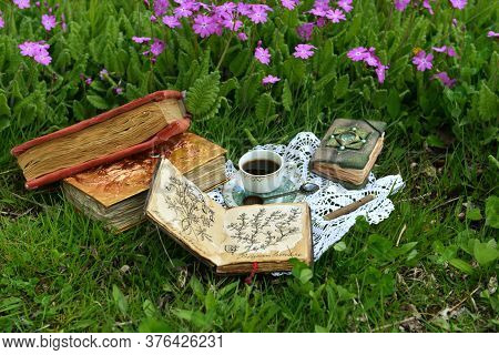 Still Life With Tea Party And Reading Book In The Garden. Esoteric, Gothic And Occult Background Wit