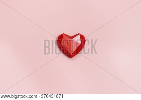 Red Polygonal Paper Heart Shape On Cream Colored Background. Holiday Background With Copy Space For 