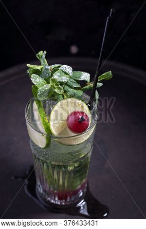 Close-up, Advertising Shot Of A Light Alcoholic Cocktail, With A Sprig Of Mint, Icing Sugar, With De