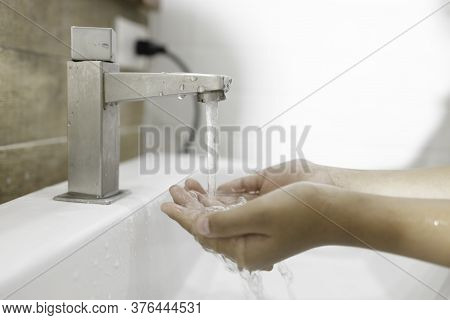Close-up of washing hands in the sink to prevent germs. Hygiene concept and virus prevention.