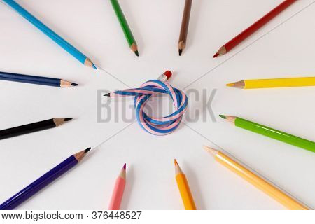 Flexible Pencil And A Set Of Colored Pencils On A Light Background. Selective Focus