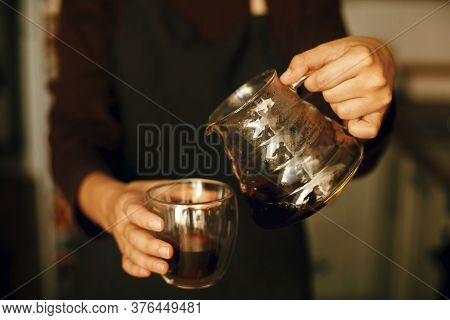 Person Pouring Fresh Aromatic Coffee From Glass Kettle In Cup. Alternative Coffee Brewing, V60. Prof