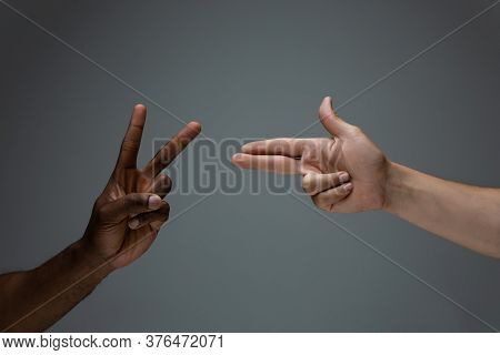 Peace And War. Racial Tolerance. Respect Social Unity. African And Caucasian Hands Gesturing On Gray