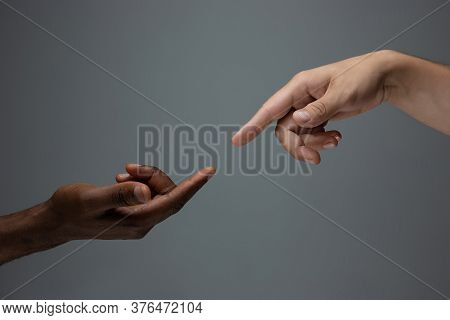 Touching Of God. Racial Tolerance. Respect Social Unity. African And Caucasian Hands Gesturing On Gr