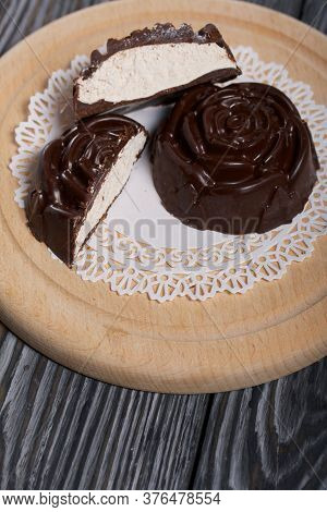 A Chocolate Marshmallow Made In The Shape Of A Rose Lies On A White Napkin. One Marshmallow Is Cut I