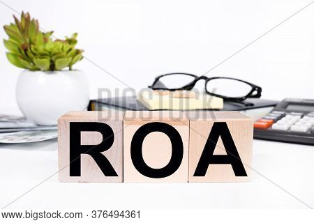Roa Return On Asset Acronym On Wooden Cubes On, White Background. Business Concept