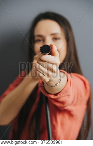 Woman Aiming With A Shower Nozzle, Blurred, Focus On A Cealed Tip