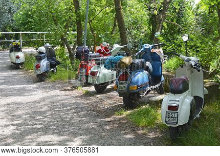 Villaggio Di Punta Sdobba, Italy - June 14 2020. Six Vespas, Part Of A Small Rally Of Vespa Motorike