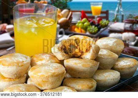 Breakfast with patty and orange juice - Empadinha, traditional Brazilian snack