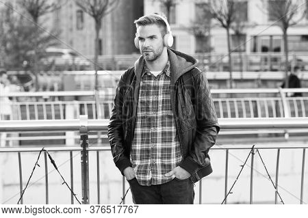 Deliver Perfect Audio Reproduction. Young Man Wear Audio Headphones Outdoor. Handsome Guy Listen To 