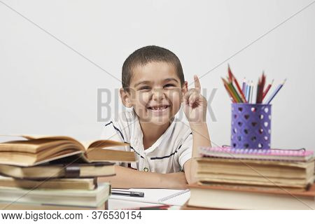 Thoughtful Schoolboy Having Idea, Raising Finger. I Know It. Primary School Pupil Thinking, Creating