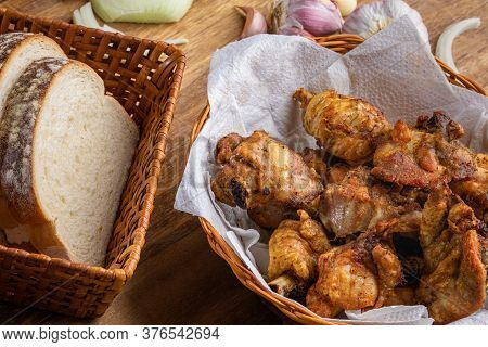 Brazilian Style Deep Fried Chicken And Sliced White Bread. Called Frango A Passarinho