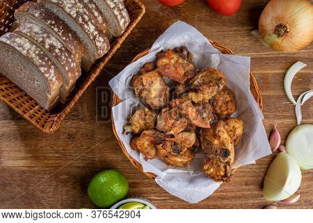 Brazilian Style Deep Fried Chicken And Sliced White Bread. Called Frango A Passarinho. Top View