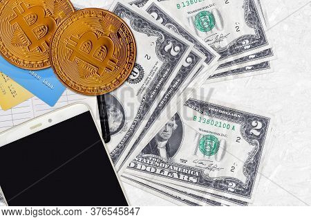 2 Us Dollars Bills And Golden Bitcoins With Smartphone And Credit Cards. Cryptocurrency Investment C