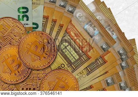 50 Euro Bills And Golden Bitcoins. Cryptocurrency Investment Concept. Crypto Mining Or Trading
