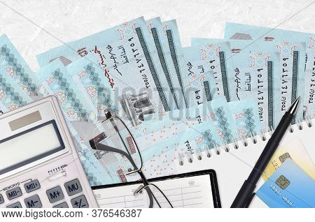 5 Egyptian Pounds Bills And Calculator With Glasses And Pen. Tax Payment Concept Or Investment Solut