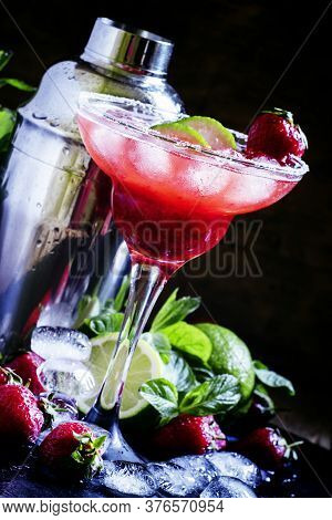 Alcoholic Cocktail With Strawberry, Lime And Ice In The Glass, Decorated With Sugar, Black Backgroun