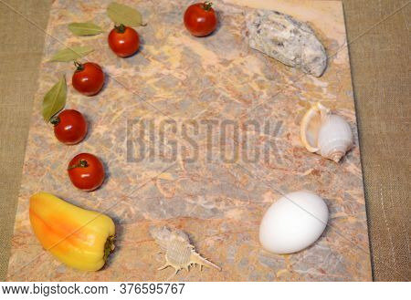 Vegetables, Chicken Eggs And Seashells On A Marble Surface With Free Space: Cherry Tomatoes, Bell Pe