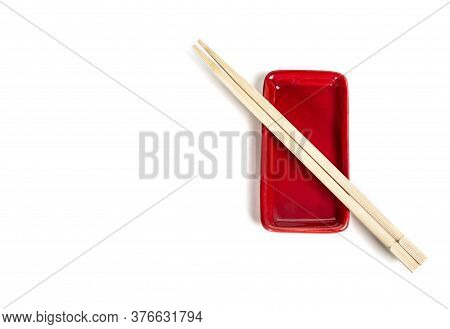 Top View Of Red Bowl Chopsticks On White Background