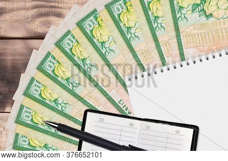 10 Sri Lankan Rupees Bills Fan And Notepad With Contact Book And Black Pen. Concept Of Financial Pla