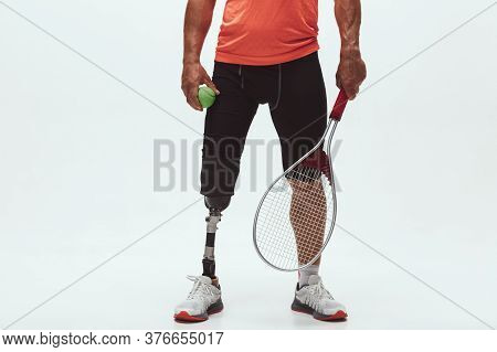 Athlete With Disabilities Or Amputee Isolated On White Studio Background. Professional Male Tennis P