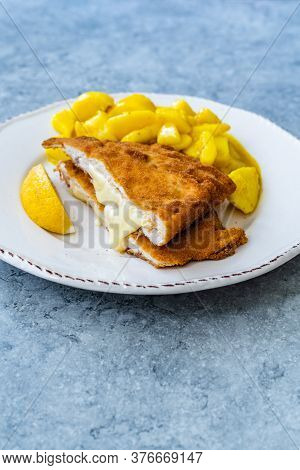 Cordon Bleu Chicken Schnitzel With Potato Salad. Half Cut.