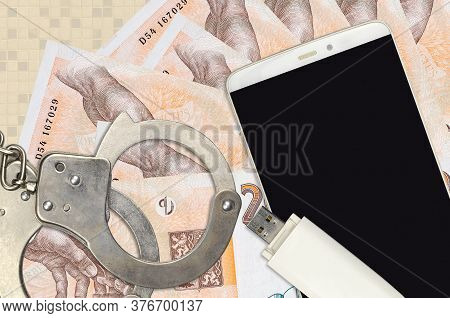 200 Czech Korun Bills And Smartphone With Police Handcuffs. Concept Of Hackers Phishing Attacks, Ill