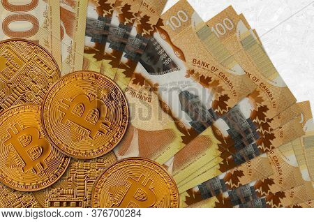 100 Canadian Dollars Bills And Golden Bitcoins. Cryptocurrency Investment Concept. Crypto Mining Or 