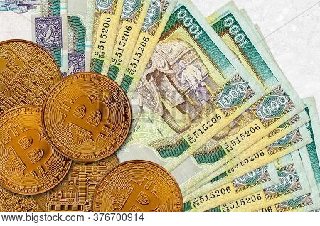 1000 Sri Lankan Rupees Bills And Golden Bitcoins. Cryptocurrency Investment Concept. Crypto Mining O