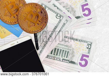 5 Us Dollars Bills And Golden Bitcoins With Smartphone And Credit Cards. Cryptocurrency Investment C