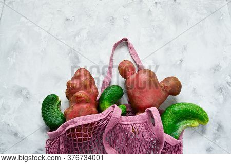 Fresh Ugly Cucumbers And Potatoes On A Concrete Gray Background. Trendy Ugly Vegetables. Imperfect F