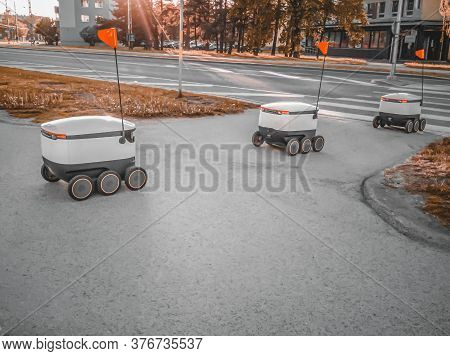 Some Delivery Robots On The Street. Estonian Cyber-couriers In Tallinn City. Sunny Summer Day. Copy 