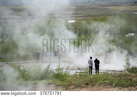 Strokkur Geyser, Iceland - May 20, 2019: Tourists Visiting And Waiting For The Eruption Of Strokkur 
