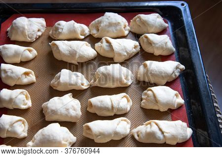 Small Homemade Croissants In The Form Before Baking.