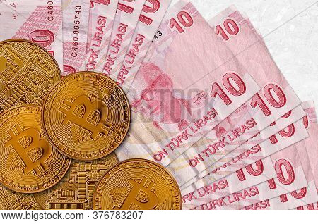 10 Turkish Liras Bills And Golden Bitcoins. Cryptocurrency Investment Concept. Crypto Mining Or Trad