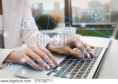 Information Security. Young Woman Using Laptop At Table Indoors, Closeup