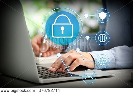 Information Security. Young Woman Using Laptop At Table Indoors, Closeup