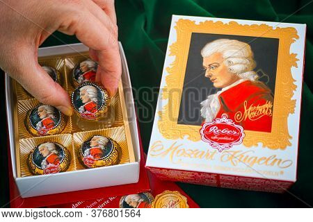 Tambov, Russian Federation - February 14, 2020 Person Hand Taking Mozart Candy From Candy Box. Green