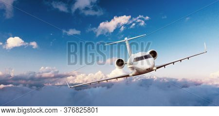 Private jetplane flying above clouds, front cabin view.