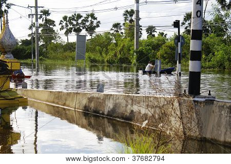 Unidentified people have to travel by boat on the road during flood