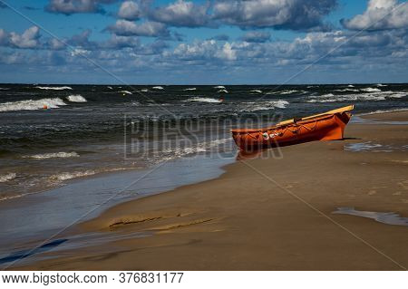 An Orange Lifeguard Boat On A Beach In Łeba In Poland On A Warm Sunny Day