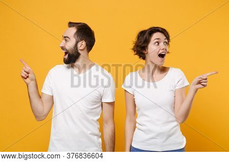 Excited Young Couple Friends Bearded Guy Girl In White Blank Empty T-shirts Posing Isolated On Yello