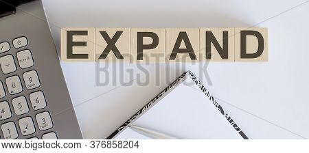 Business Concept Text On Wood Block Expand With Laptor And Notebook