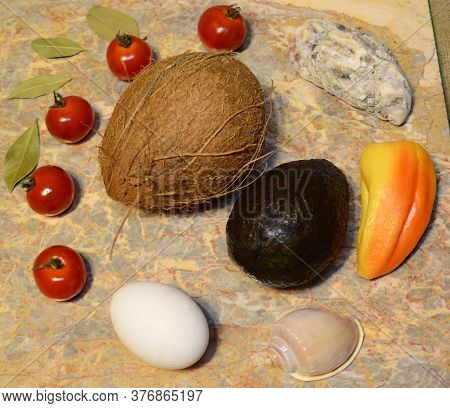 Vegetables, Fruits, Seashells And An Egg On A Marble Surface: Cherry Tomatoes, Bell Peppers, Bay Lea
