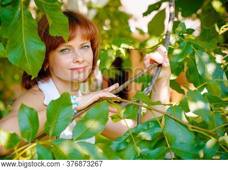 Miniature Mature Woman Resting On Nature And Enjoying Weekend. The Concept Of Harmony With Life And 